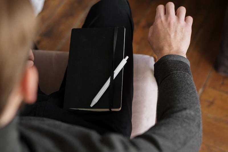 Person in Gray Long Sleeve Shirt Holding Black Tablet Computer